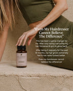 Person holding a bottle of hair product with text about hair thickness and growth.